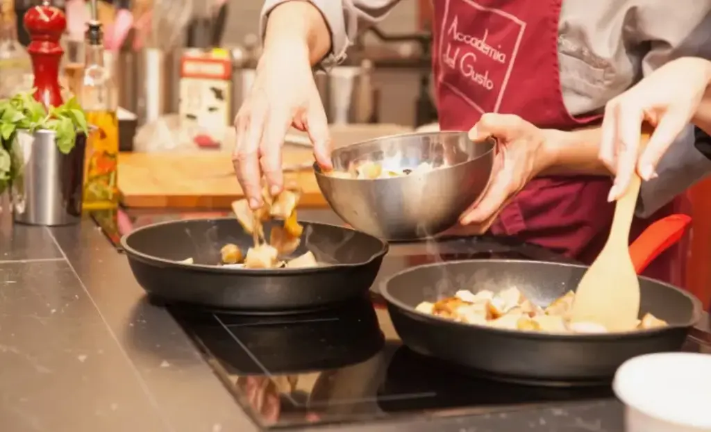 Кулинарный мастер-класс, повара готовят блюдо на сковородах