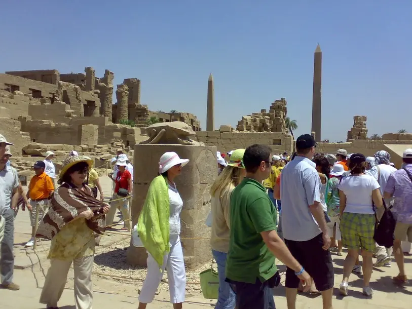 Экскурсионная группа среди древних храмов отражает атмосферу отдыха и показывает погоду по месяцам в Египте, включая мягкие условия октября.