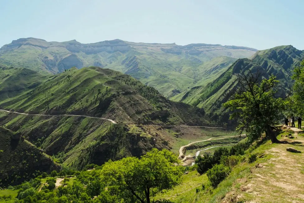 Готовый туристический маршрут по Дагестану с зелёными горными хребтами, серпантином и панорамным видом на долину