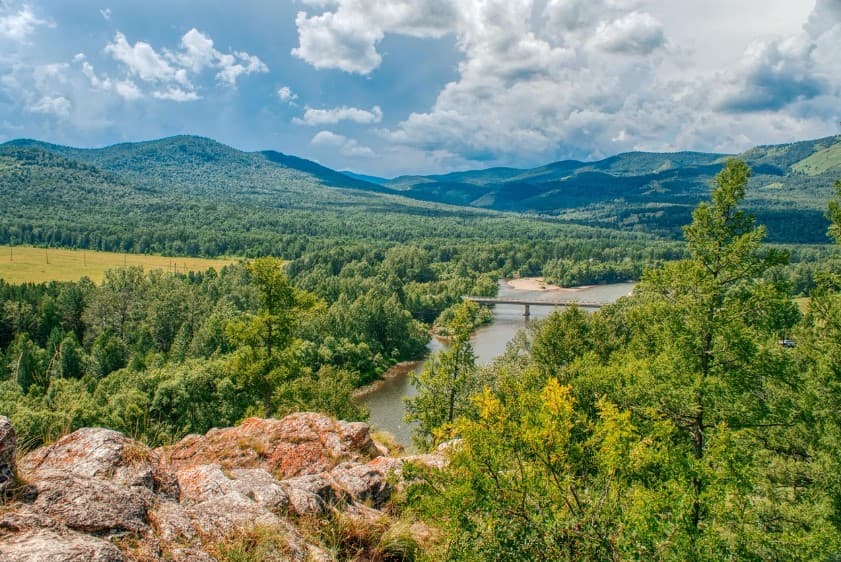 Лучшие экскурсии осенью по России для всей семьи — горная долина, река и лес под облачным небом
