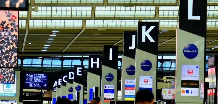 Пересадки в турах: когда это нормально, а когда лучше отказаться — табло и указатели в аэропорту перед вылетом